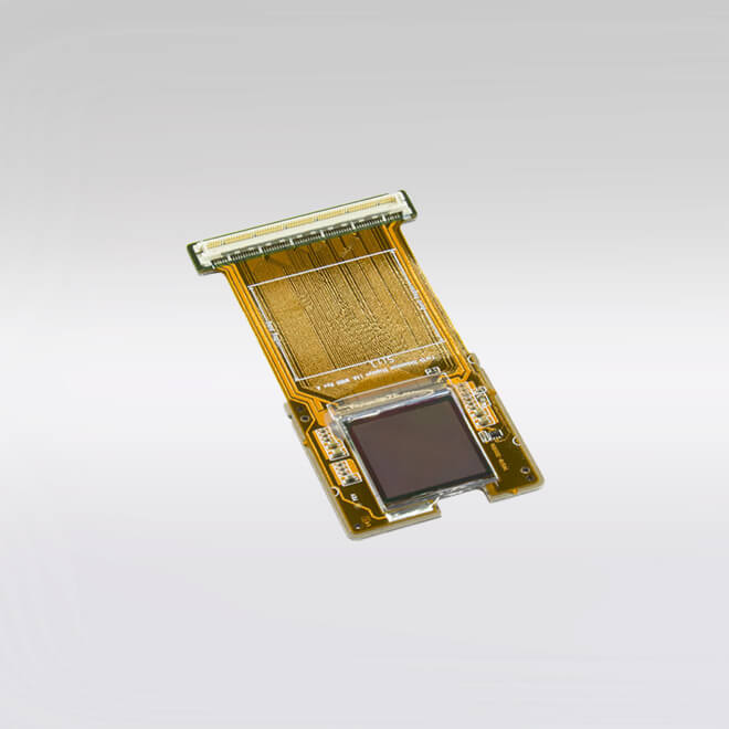 A high-performance Kopin 2K-R11 microdisplay and spatial light modulator, featuring a central dark square display panel mounted on a gold-toned flexible printed circuit board (PCB) with visible intricate wiring and a multi-pin connector at the top.