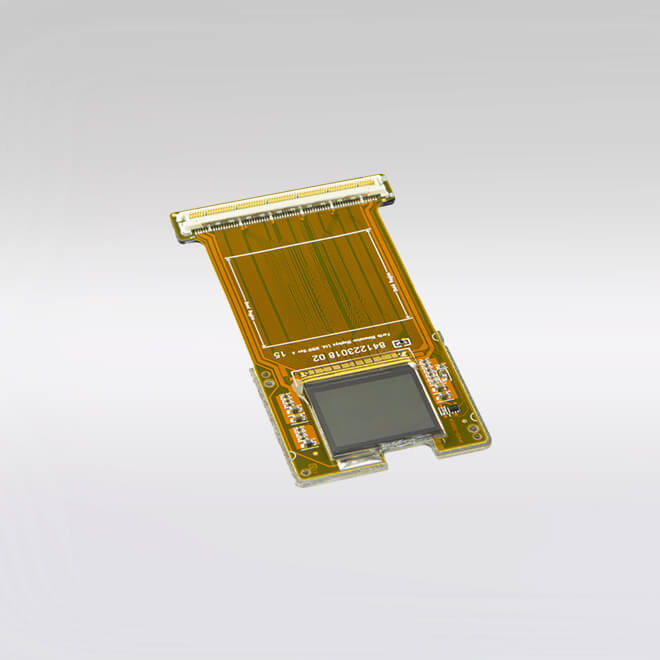 An FLCoS microdisplay and Spatial Light Modulator by Kopin, featuring a small reflective screen on a gold-trace PCB with a wide ribbon connector.