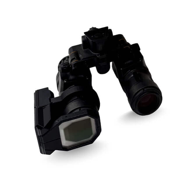 A pair of night vision goggles with a clip‑on augmented reality module attached to the front. The device has two cylindrical optical tubes connected by a central hinge, and a rectangular AR component mounted on one side with a reflective viewing surface. The equipment is shown isolated on a white background to represent Kopin’s DarkWAVE clip‑on AR system for night‑vision goggles.